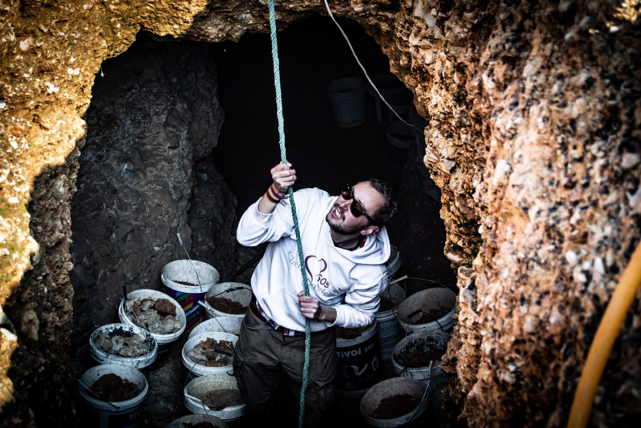 Volunteers help the Greek Catholic parish priest of Jdeide to dig a shrine in a cave